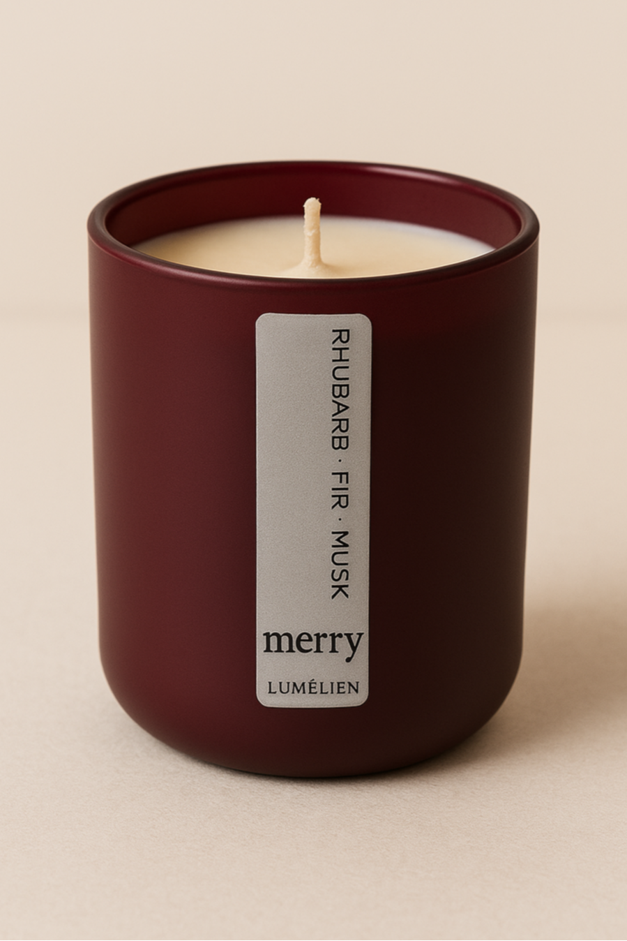 Candle with a label on a beige background